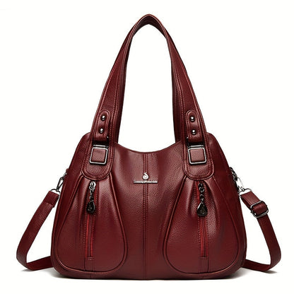 Women’s casual shoulder bag in burgundy red with top handles and adjustable shoulder strap.