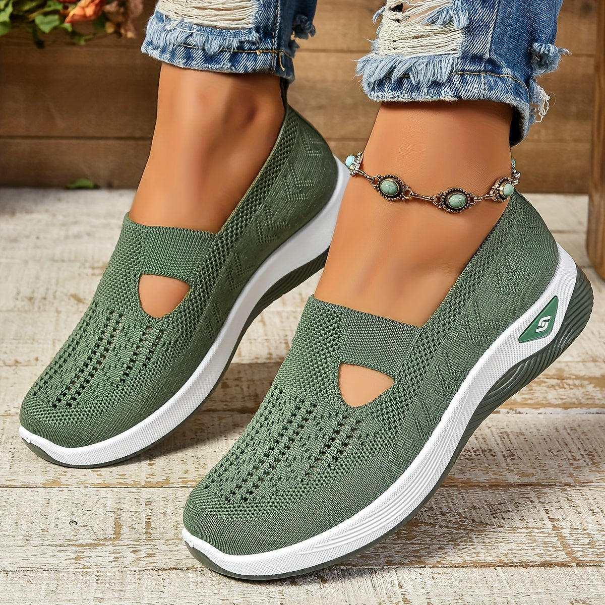 Green knit slip-on orthopedic shoes with side cutouts and white cushioned sole