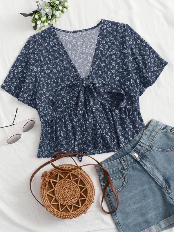 Navy blue floral v-neck flowy top with short sleeves and tied front detail