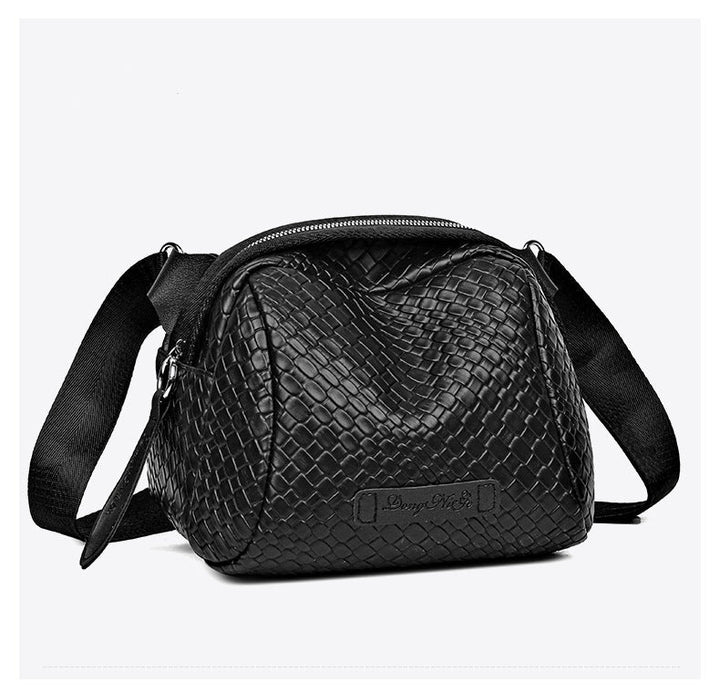 Black woven-texture shell crossbody bag with zip top and front logo patch