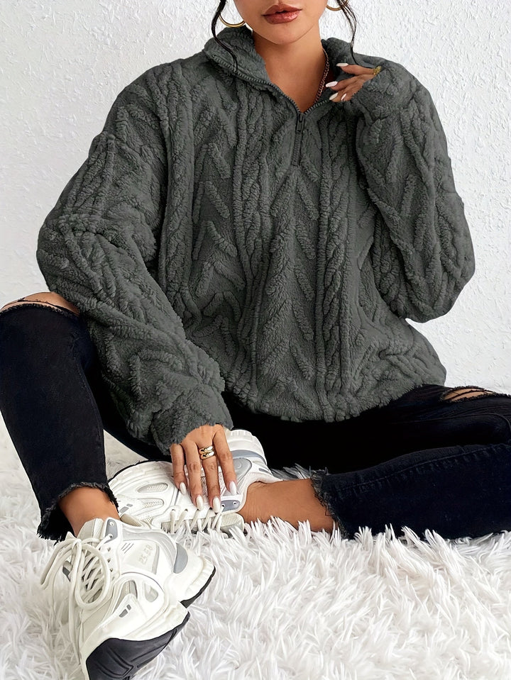 Warm knit quarter-zip sweater in dark gray with cable texture and stand collar.