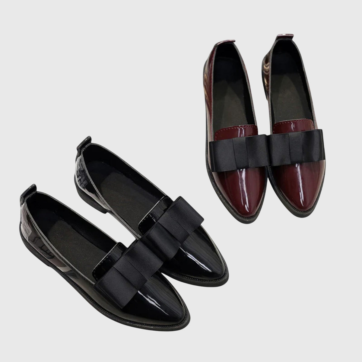 Two-tone set of black and burgundy patent loafers with wide black strap