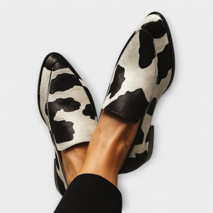Contemporary moccasins with black-and-white cow print leather, slip-on style