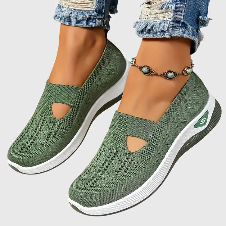 Green slip-on orthopedic walking shoe, knit upper with open toe cutouts, white sole.