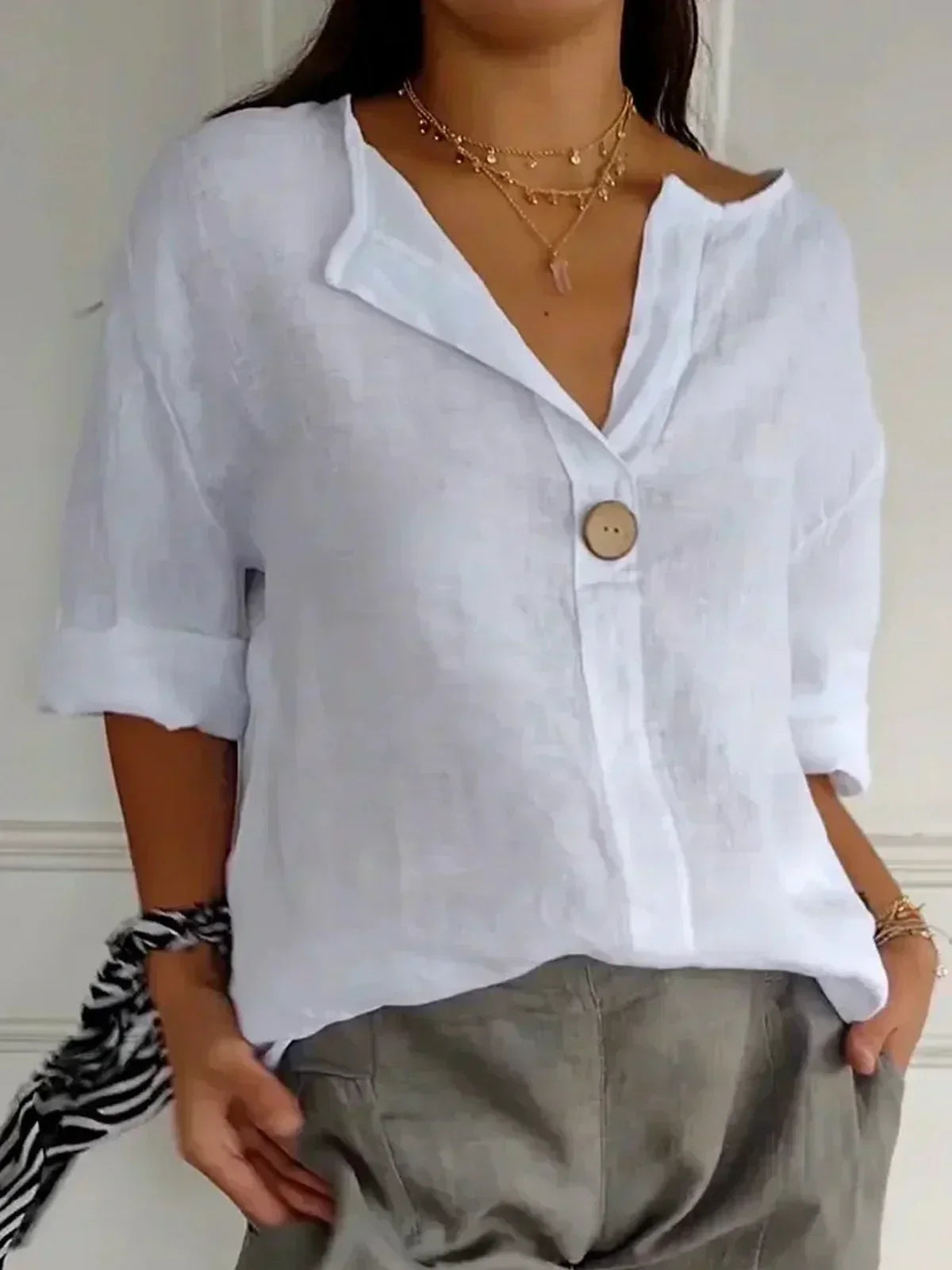 White V-neck blouse with button front and elbow-length sleeves