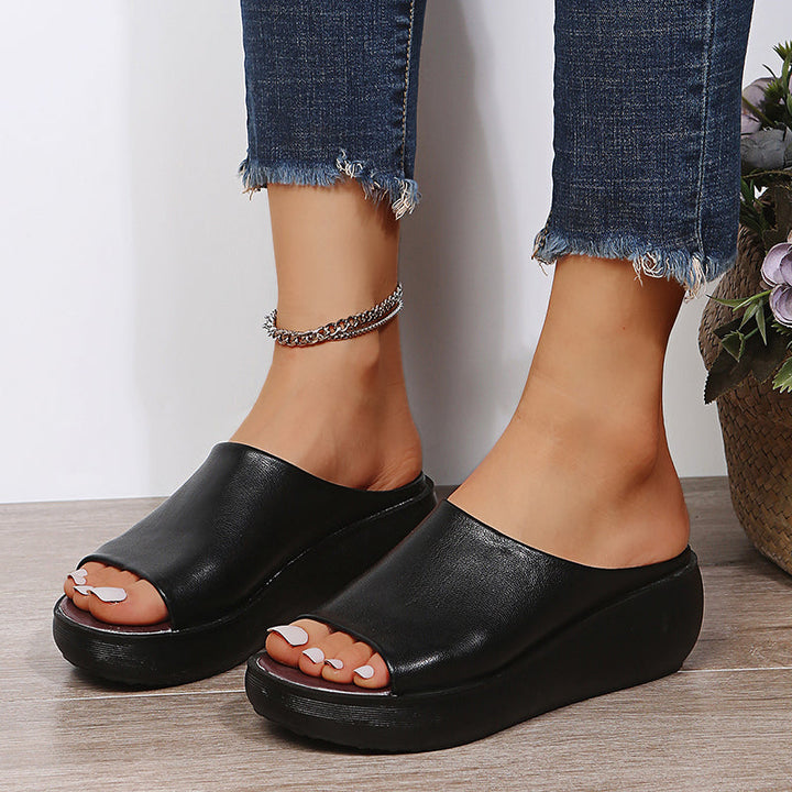 Black orthopedic slide sandals with wide open toe and thick platform sole