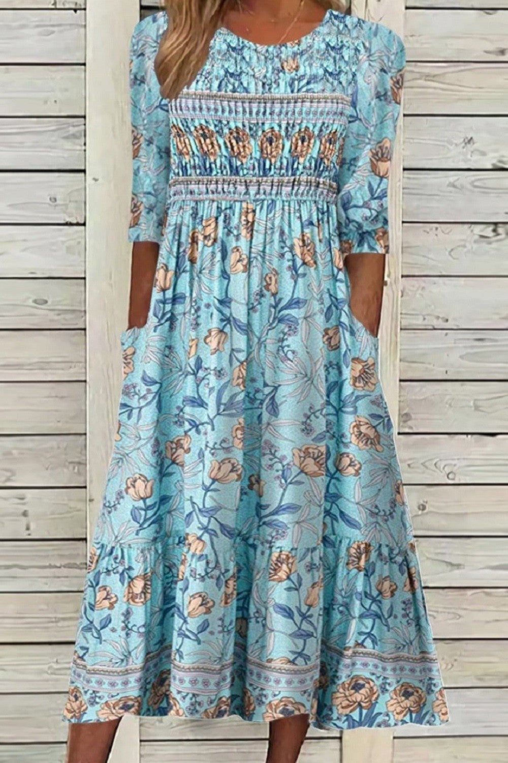 Blue floral midi dress with puffed sleeves, gathered waist, tiered skirt