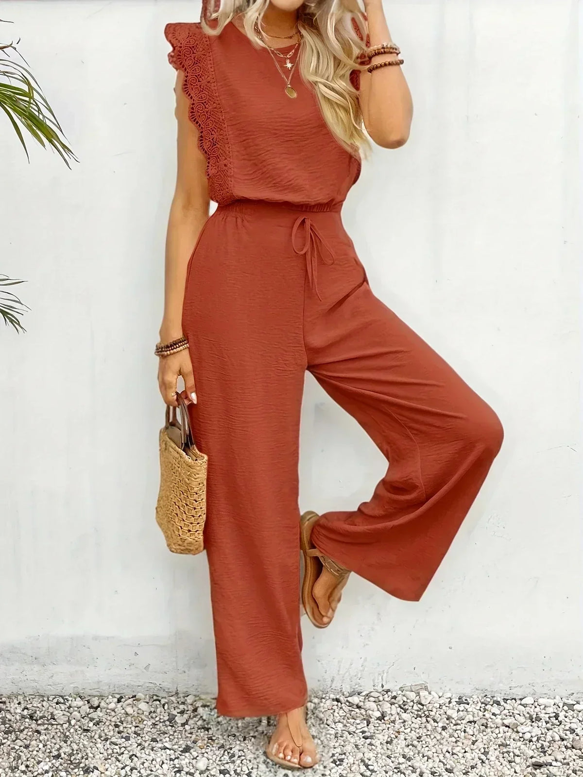 Two-piece set in rust red: lace-trim sleeveless top and wide-leg trousers