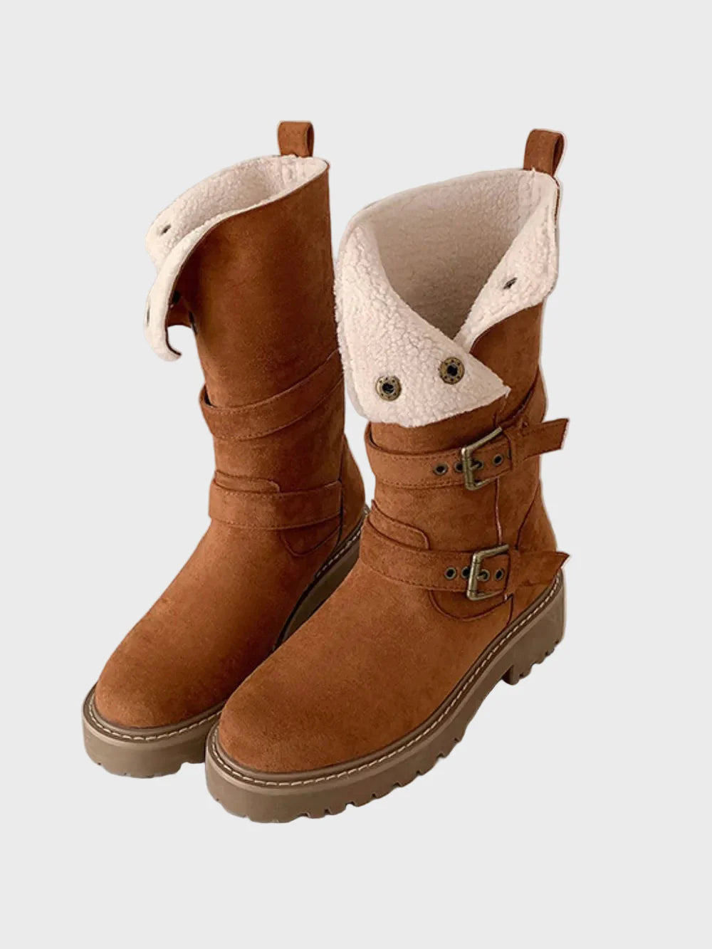 Brown high boots with white sherpa lining, front buckles, and thick tread sole