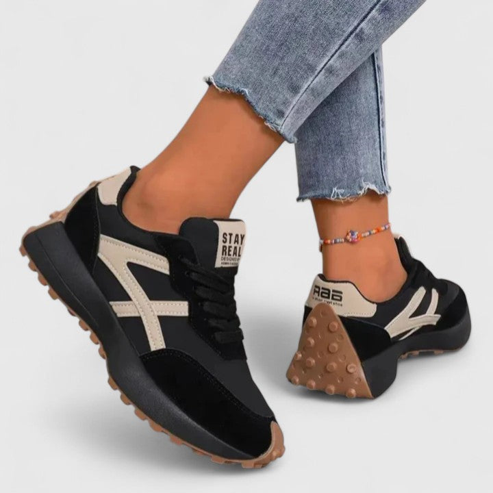 Black cloud sneakers with cream stripes, lace-up front and chunky tread sole