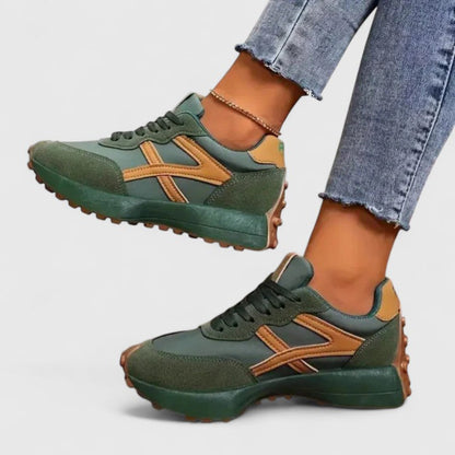 Green cloud sneakers with tan accents, lace-up front and chunky tread sole