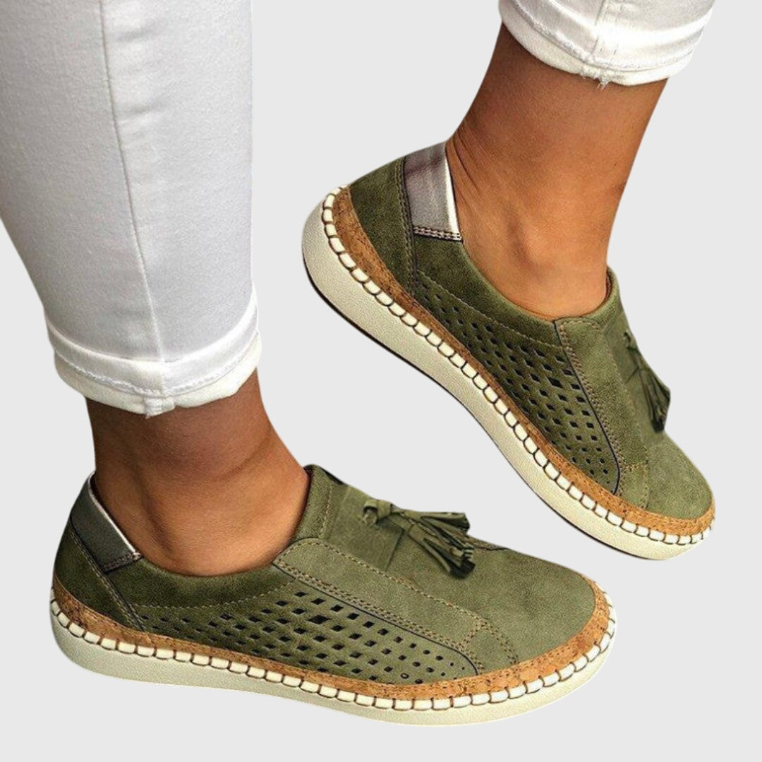 Green orthopedic slip-on shoes with tassel detail, perforated upper, cushioned outsole