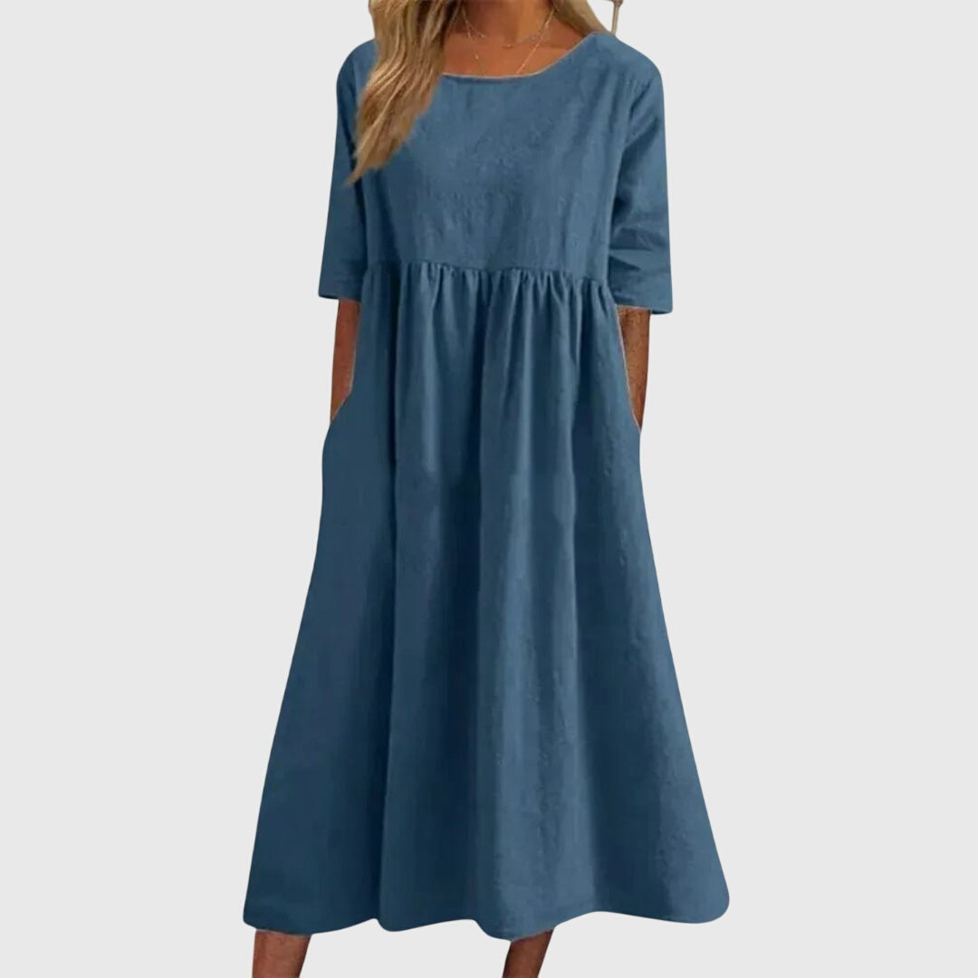 Blue short-sleeve dress with round neck, gathered waist, and full midi skirt