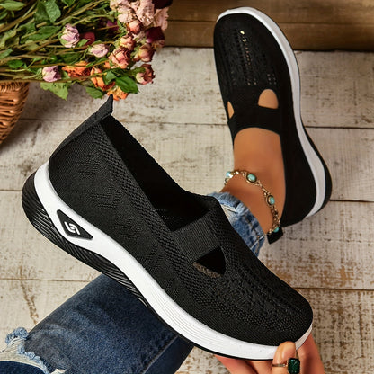 Black knit slip-on orthopedic shoes, side profile with cutout and white sole