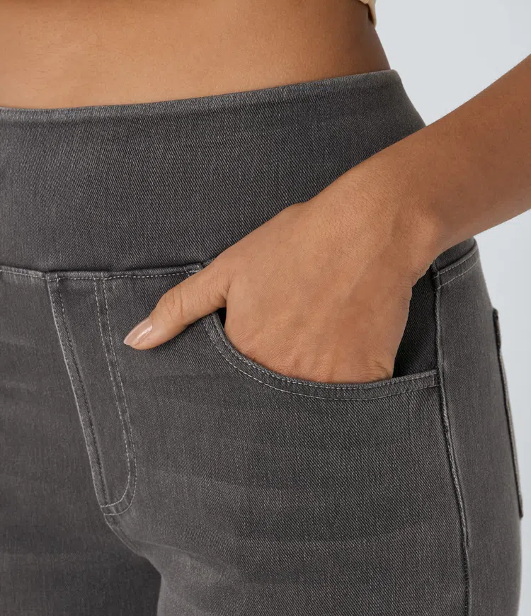 Dark charcoal denim pocket detail with stitched seam and relaxed waistband