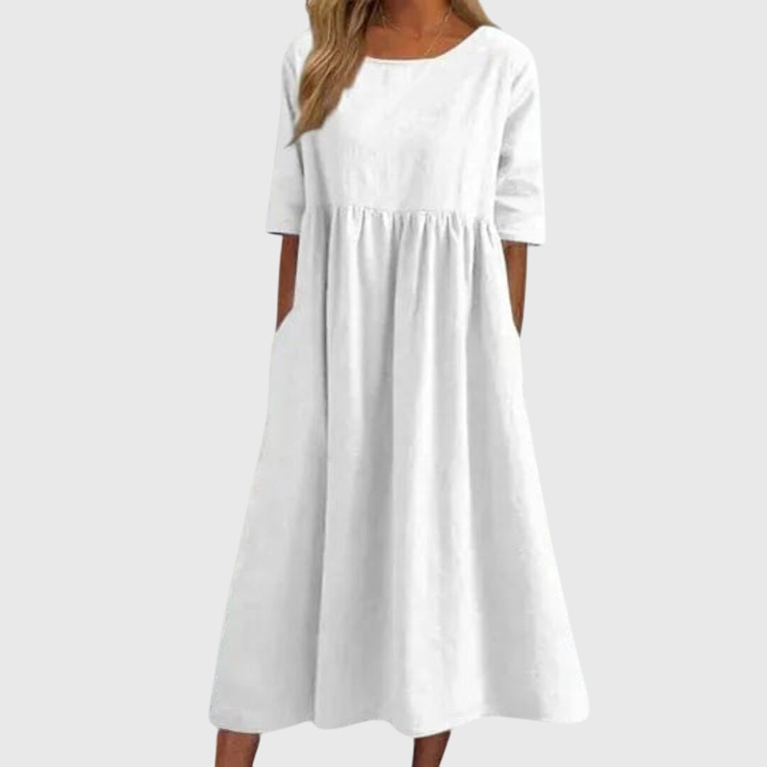 White short-sleeve dress with round neck, gathered waist, and full midi skirt