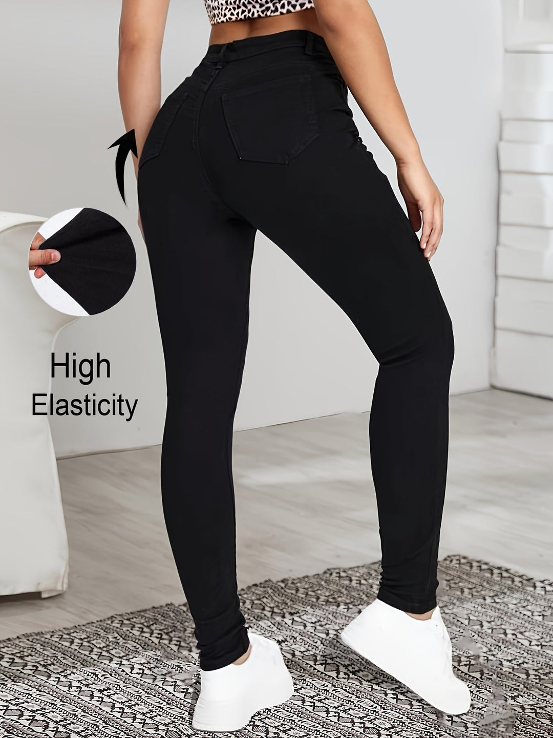 Black high-waist skinny jeans back view with back pockets and slim tapered legs