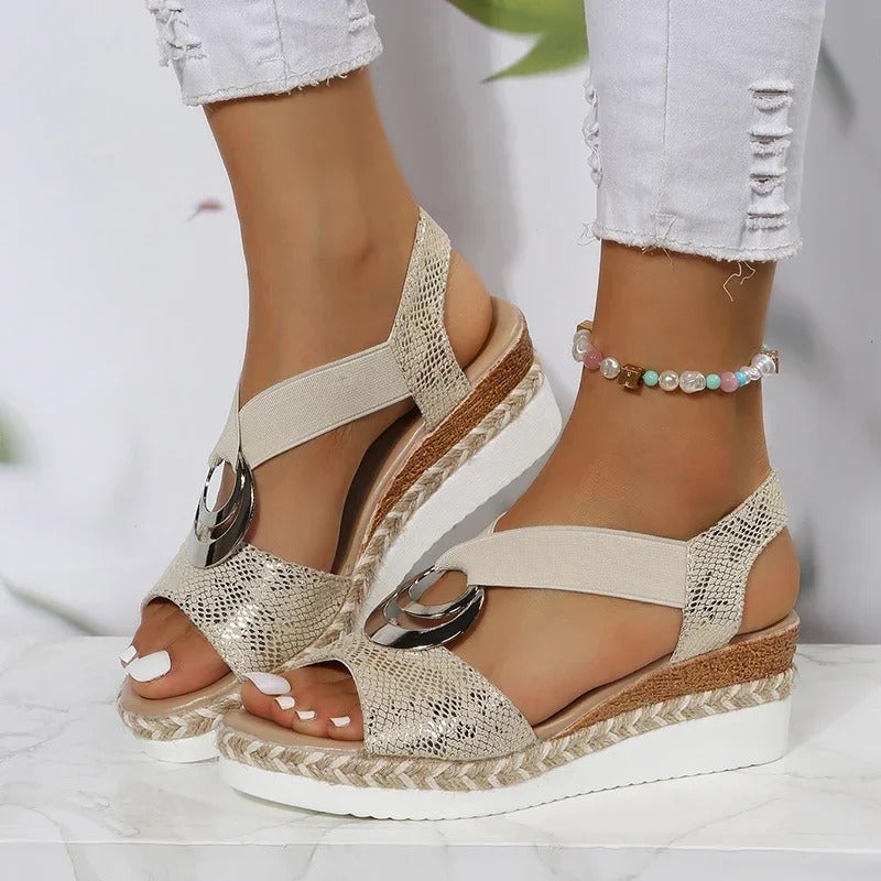 Beige platform espadrille sandals with snake-texture straps and metallic ring buckle