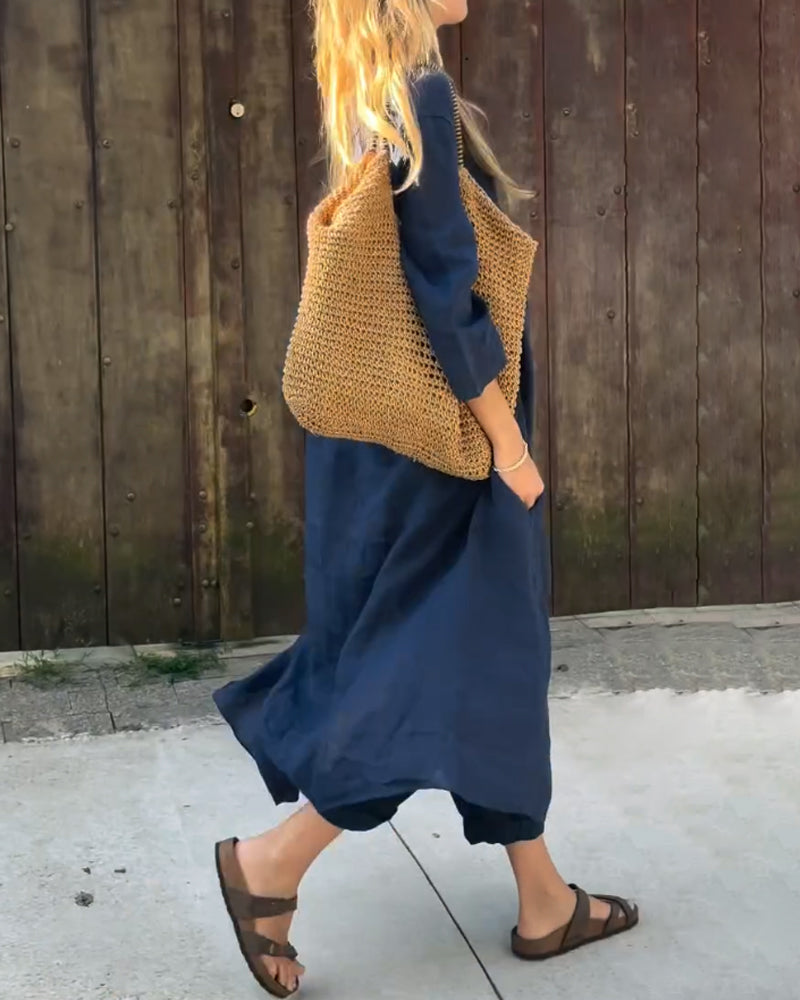 Navy blue two-piece set with V-neck tunic top and relaxed cropped pants, side view