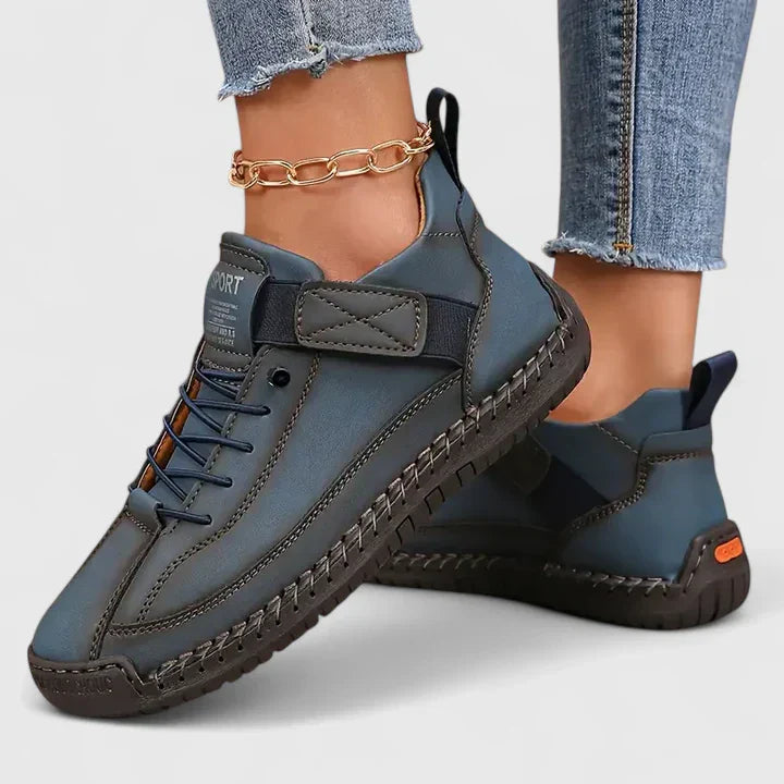 Orthopedic sneakers in dark blue with lace-up front, padded heel, and stitched rubber outsole