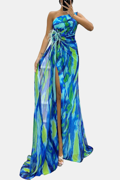 Blue strapless maxi dress with abstract print, feathered floral detail, and front slit