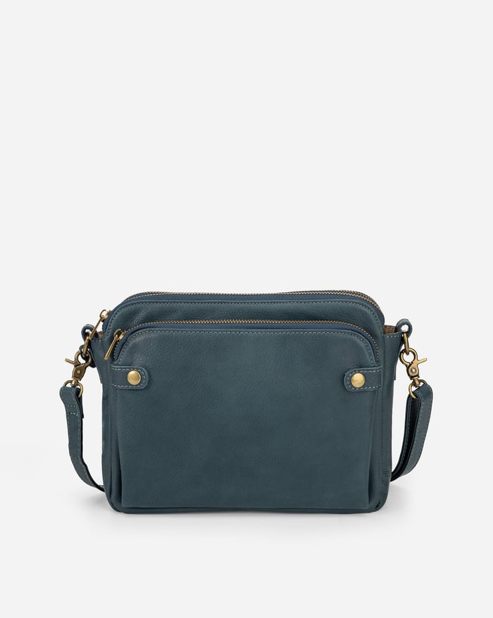 Teal-blue sleek crossbody bag with zip top, front pockets, and adjustable shoulder strap