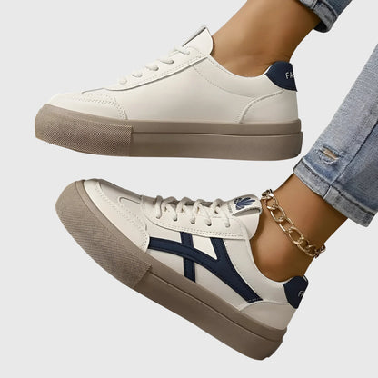 White orthopedic sneakers with navy stripes and tan rubber sole, lace-up side view