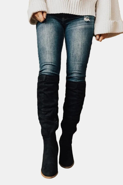 Black knee-high heeled boots with stacked block heel and pointed toe