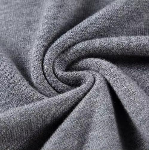 Gray knit fabric close-up with twisted yarn texture