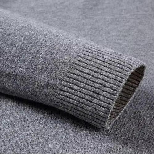 Gray ribbed sweater cuff and knit sleeve close-up