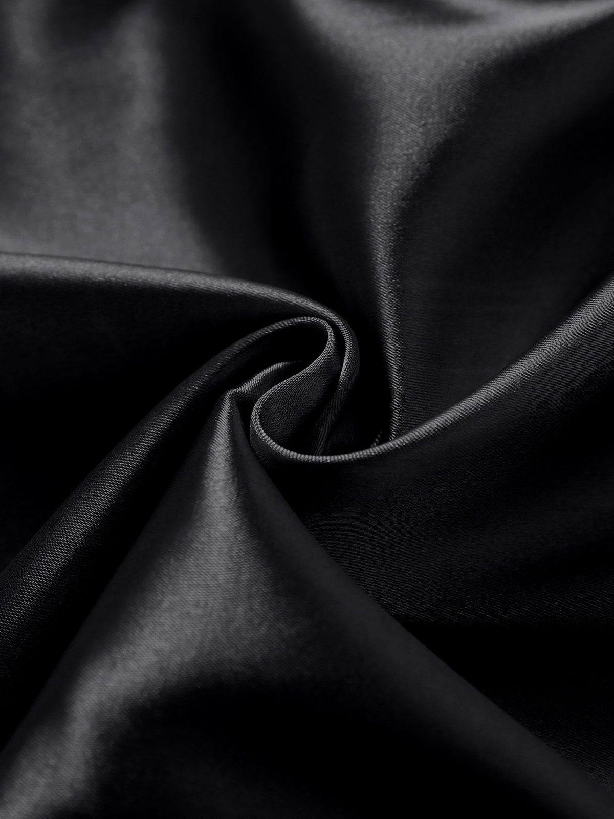 Black satin fabric close-up with soft sheen and smooth draped texture