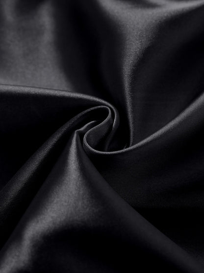 Black satin fabric close-up with soft sheen and smooth draped texture