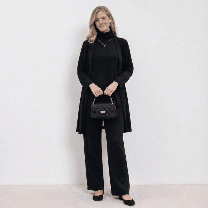 Black knit cardigan, turtleneck top and wide-leg trousers set.