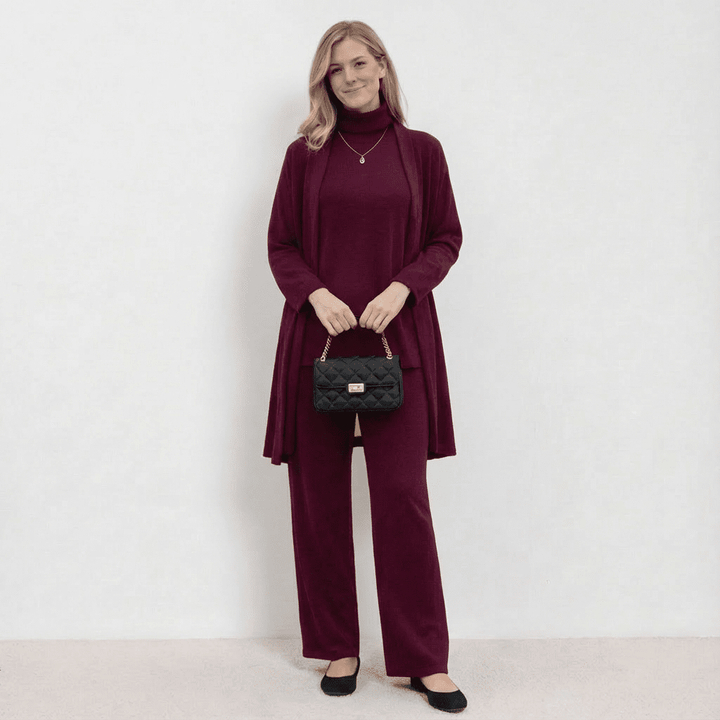 Burgundy knit cardigan, turtleneck top and wide-leg trousers set.