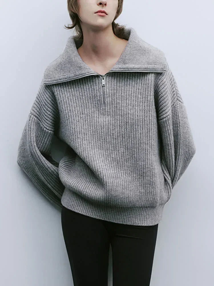 Gray knit half-zip sweater with long sleeves and ribbed stand collar, front zipper