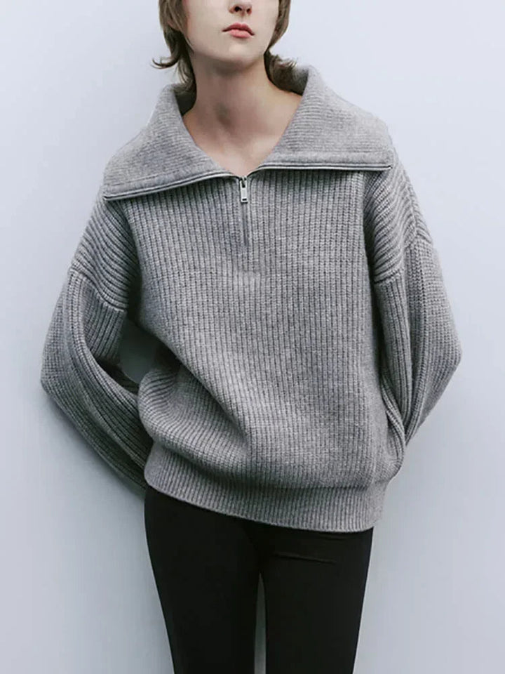 Gray knit half-zip sweater with long sleeves and ribbed stand collar, front zipper