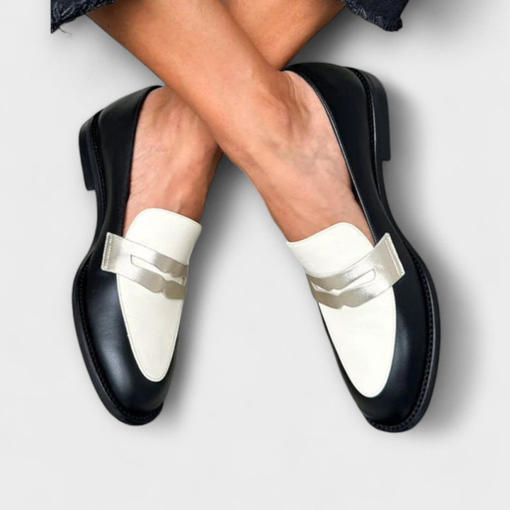 Two-tone metallic loafers with black uppers and white metal strap