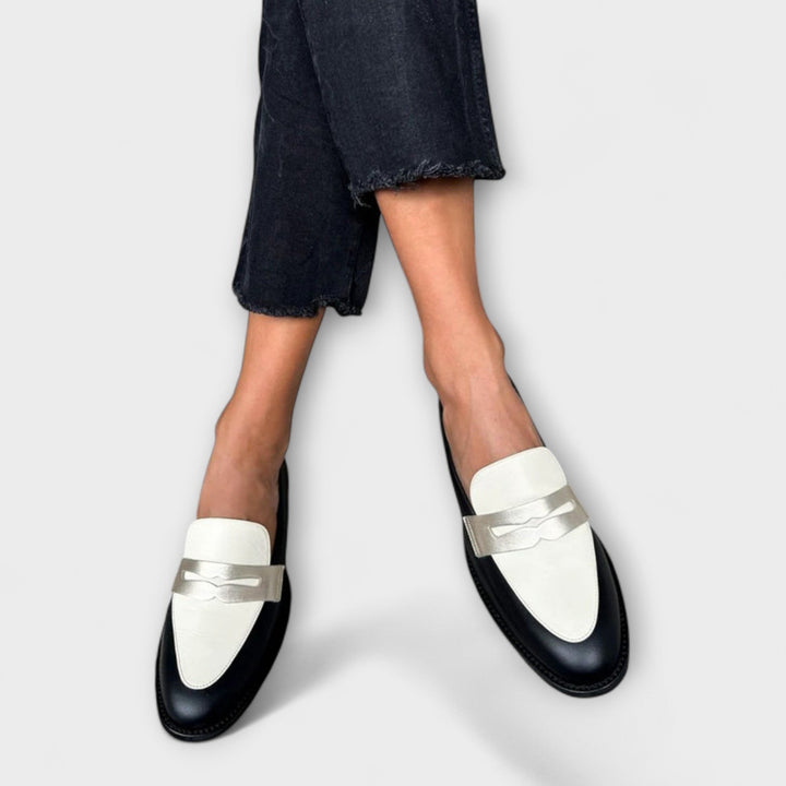 Two-tone metallic loafers with white metal straps and black rounded toe
