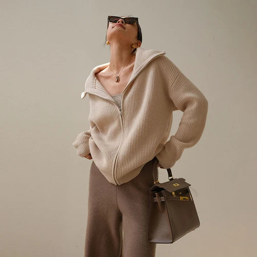 Cream knit half-zip sweater with long sleeves, stand collar, and front zipper