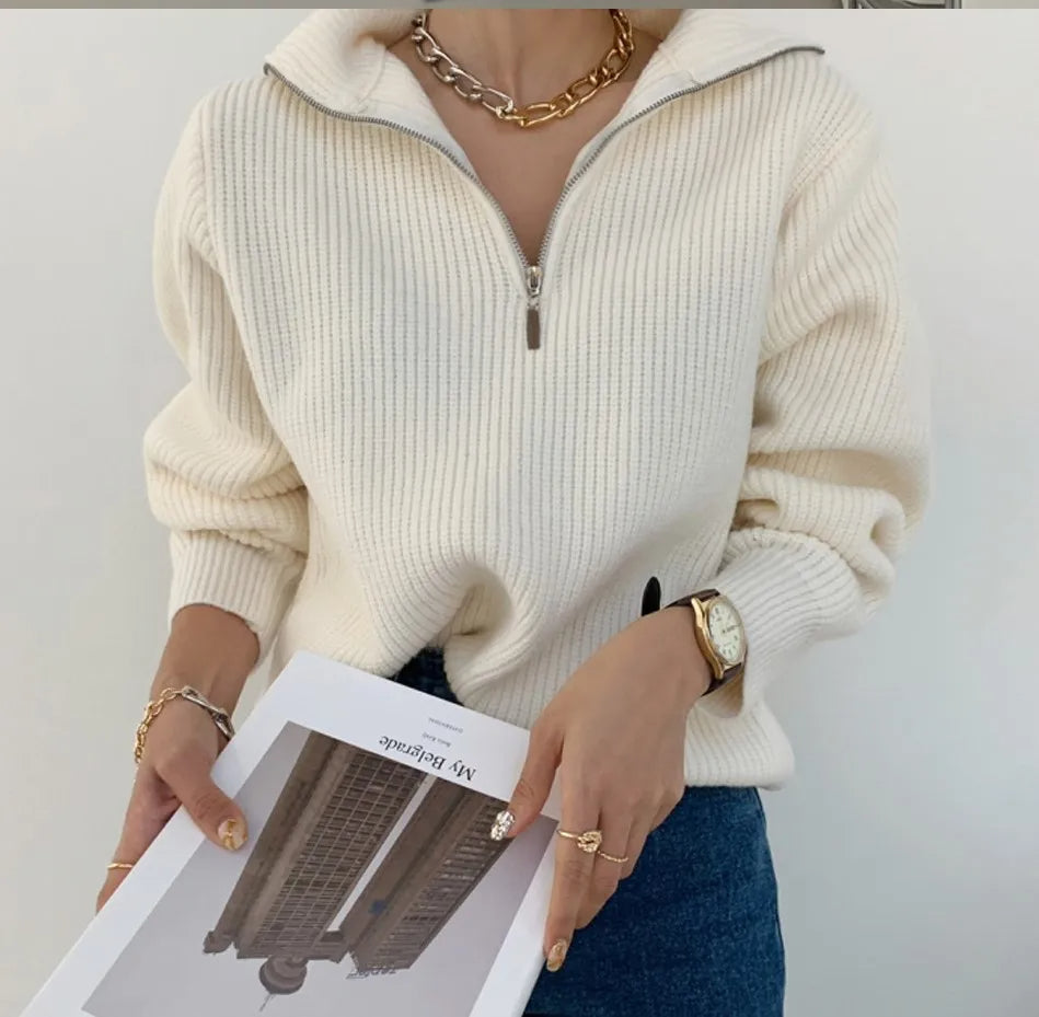 Cream knit half-zip sweater with long sleeves and ribbed stand collar, front zipper