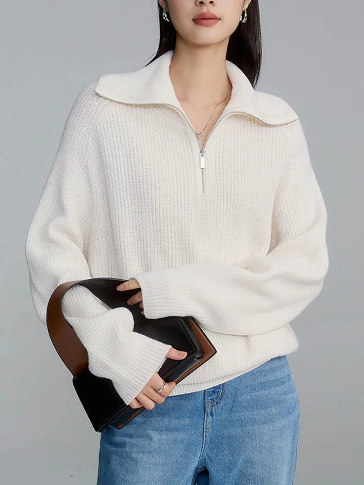 White knit half-zip sweater with long sleeves and stand collar, front zipper
