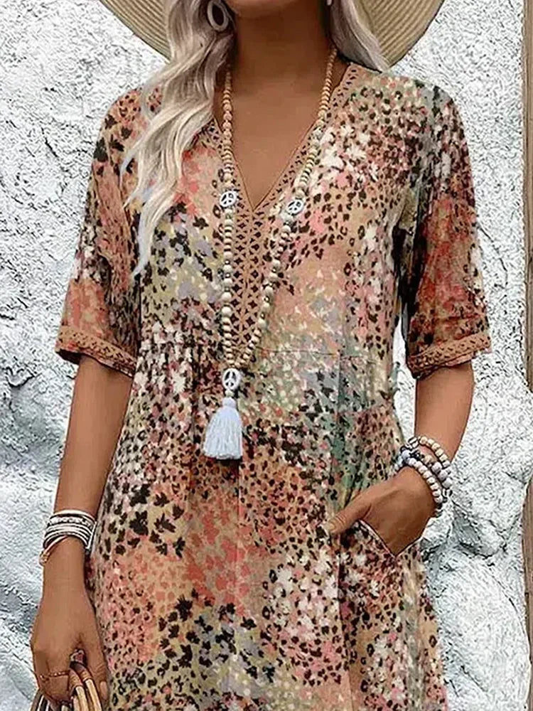 Mid-length V-neck dress, sandy beige with multicolor speckled pattern and tassel button placket