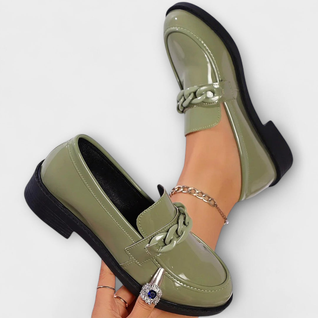 Merry round-toe casual loafers, glossy green patent with braided chain detail and low heel