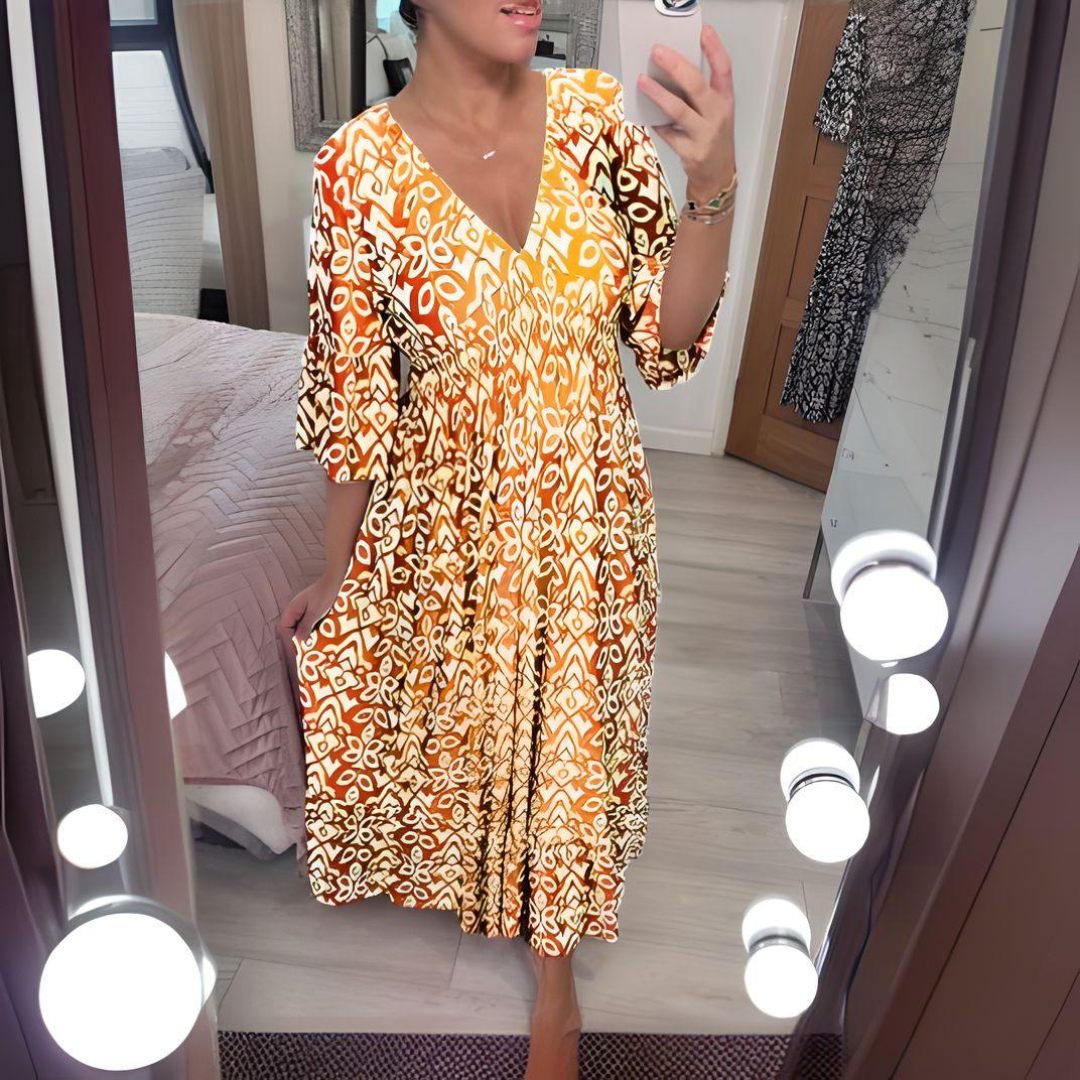 Orange boho printed dress with V-neck and three-quarter flared sleeves, tiered hem