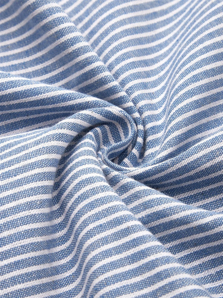 Blue striped fabric close-up with thin white lines and textured weave