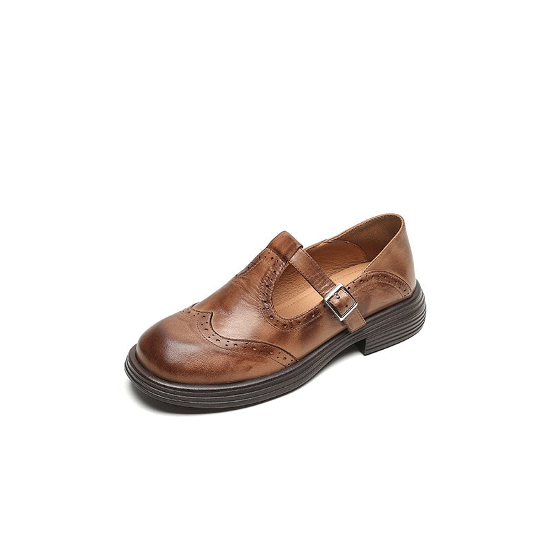 Brown leather Mary Jane slip-on with buckle strap and wingtip stitching, low block heel.