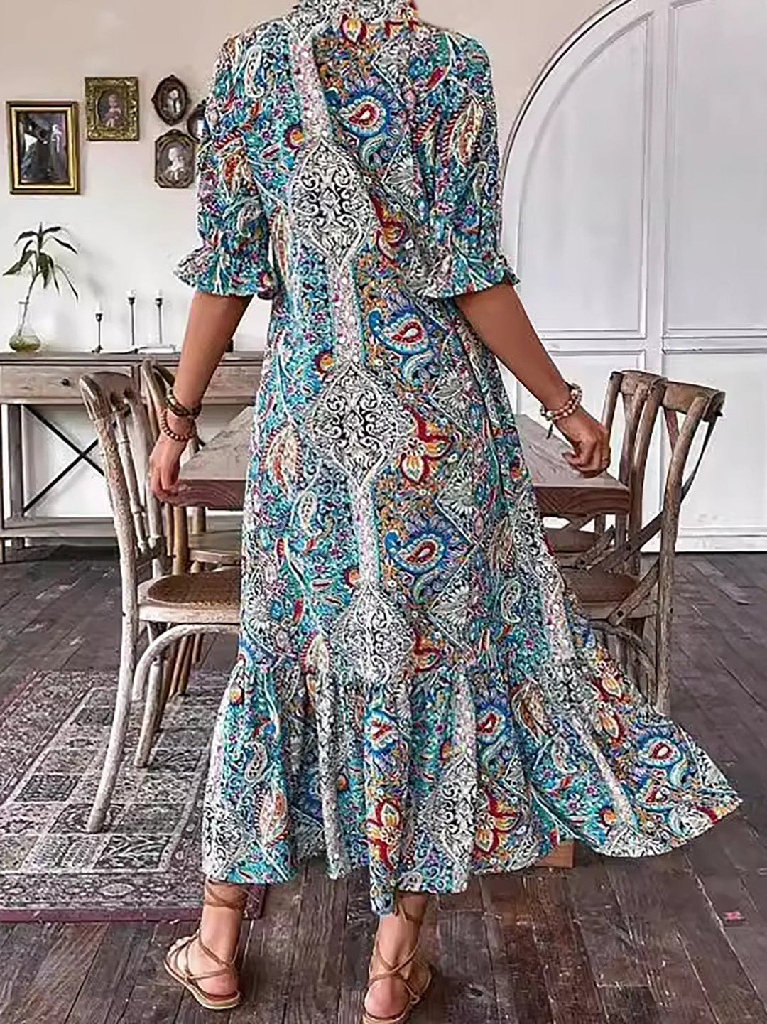 Boho grace dress in teal and blue paisley print, standing view, tassel neckline, long tiered hem