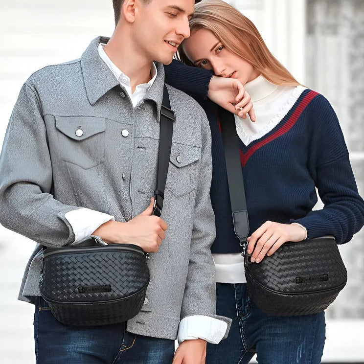 Black woven-texture shell crossbody bag with zip top and adjustable shoulder strap