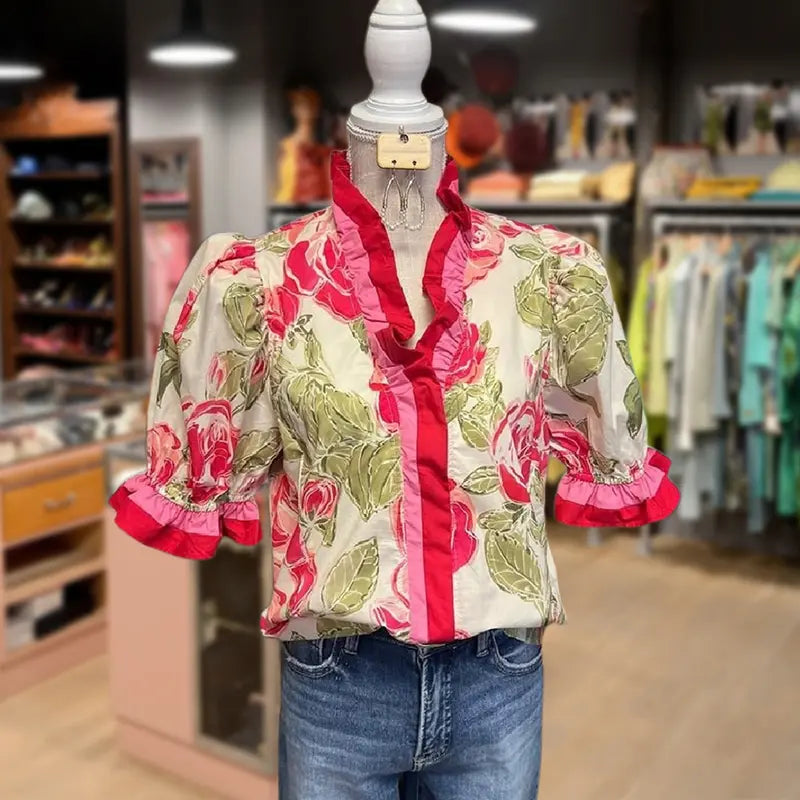 Floral ruffle stripe blouse with red trim, white base, and puff sleeves