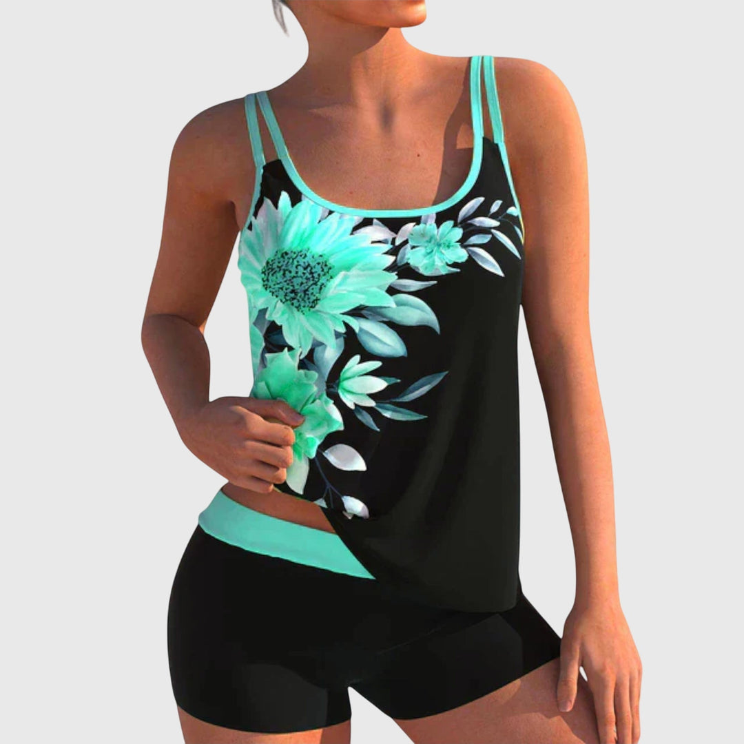 Two-piece swimsuit with turquoise floral print on black, teal trim, scoop neck